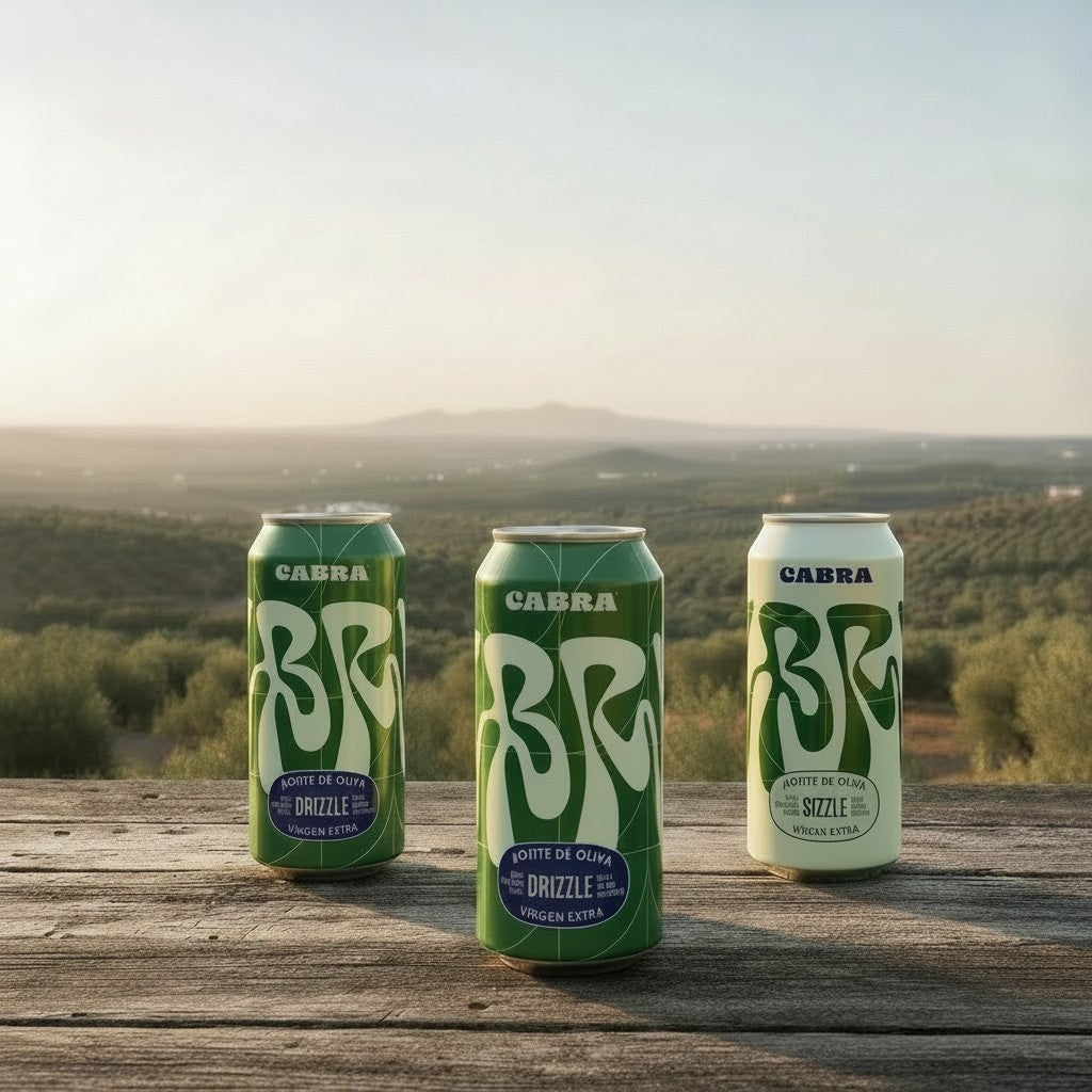 Cabra Olive Oil refill set featuring three green and white cans on a wooden table overlooking an olive grove.